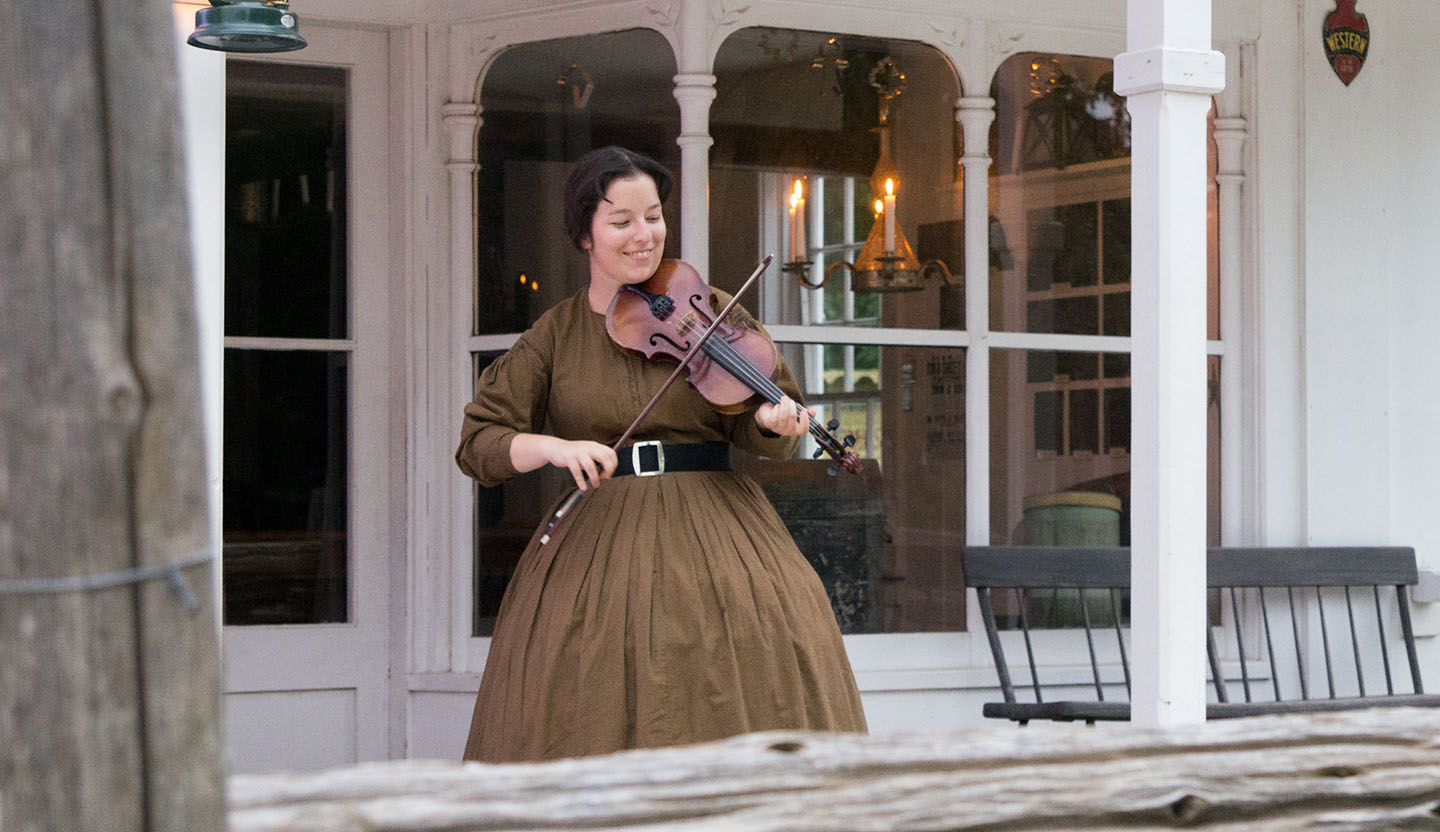 young woman plays a fiddle