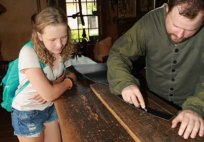 student learns about woodworking on a field trip to Black Creek Pioneer Village