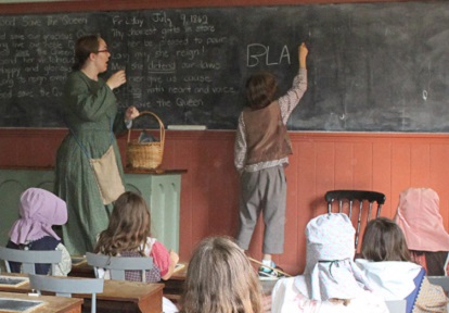 students take part in a re-creation of a pioneer school day