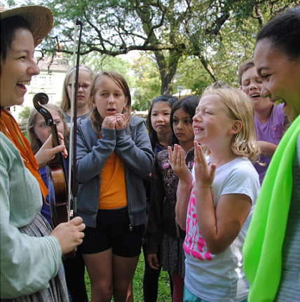 Get Hands-On 3 fiddler demonstrates instrument for children