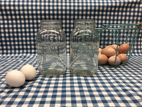 eggs sit next to jars filled with cold water