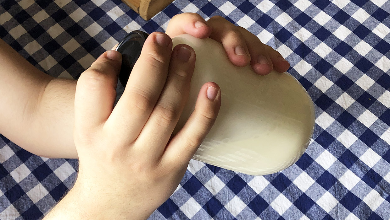 Mason jar full of cream being shaken