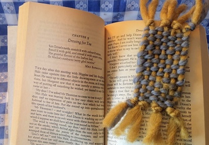 crafter marks page with woven bookmark