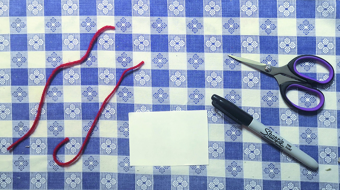 scissors with string and other supplies for making an optical toy