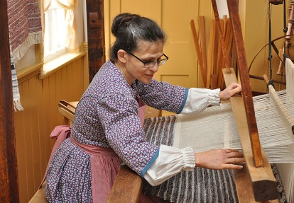 a weaver works on a loom