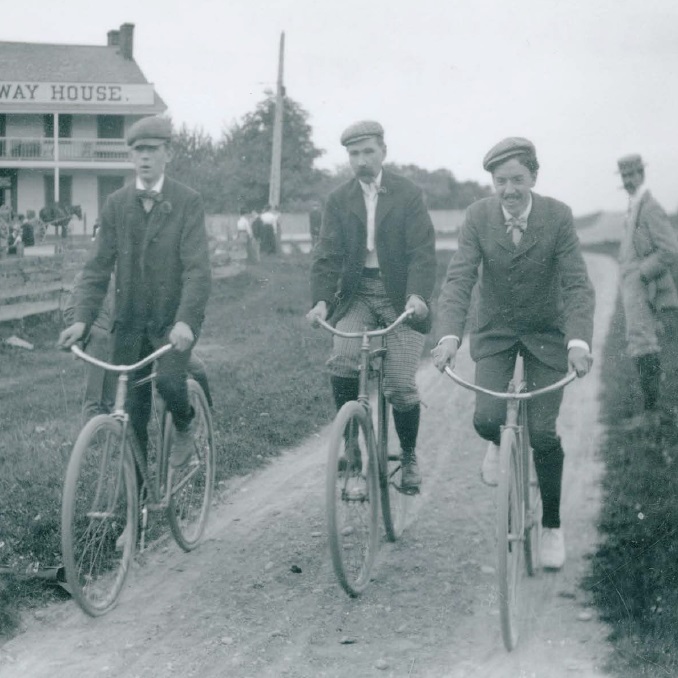 early 20th century photograph of three young men on bicycles