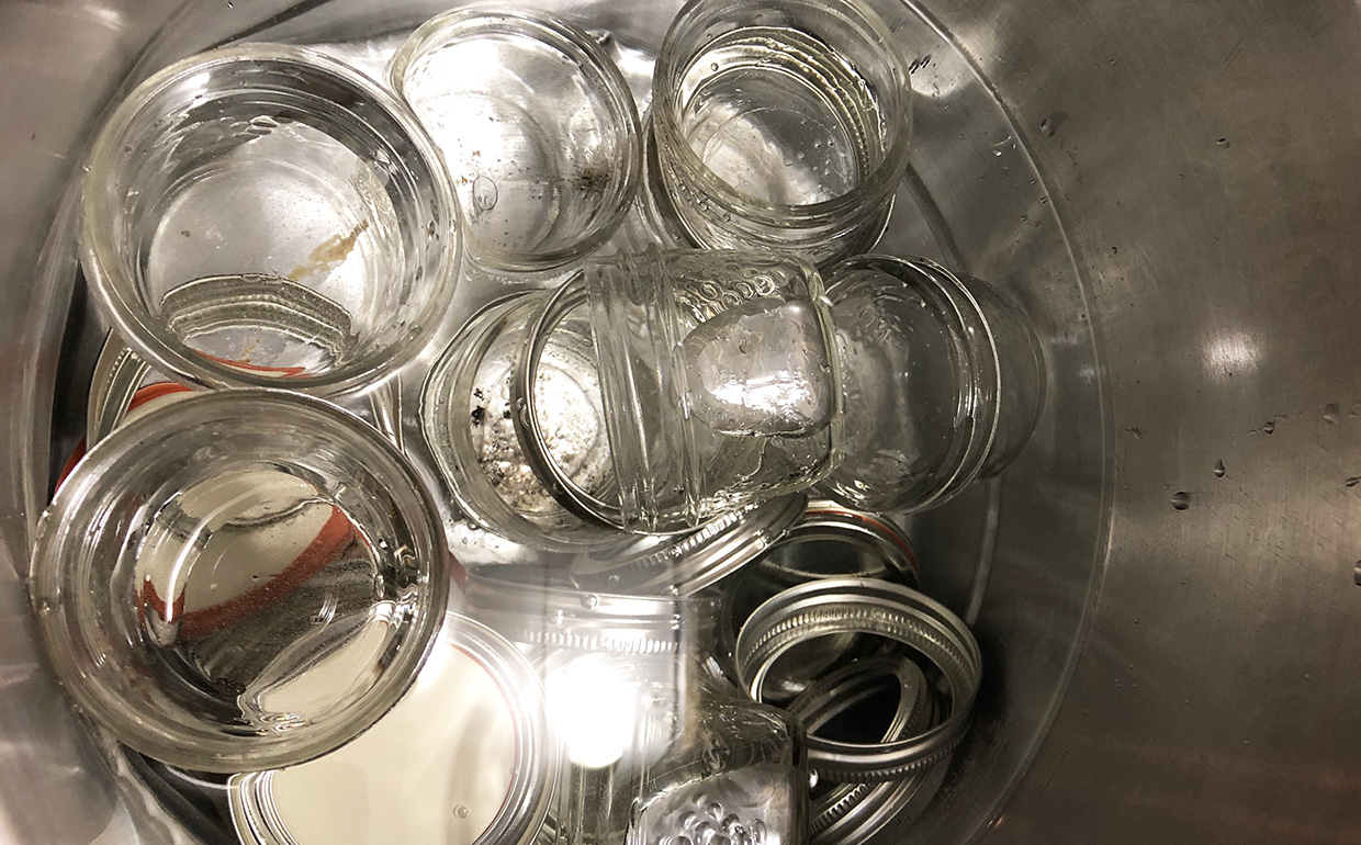 jam jars in a pot with seals and lids