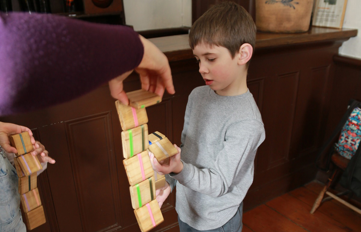 a boy at Black Creek plays with a Jacobs Ladder