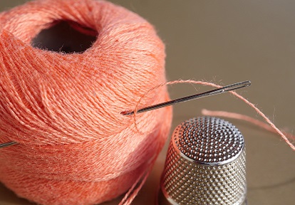 sewing thread with needle and thimble