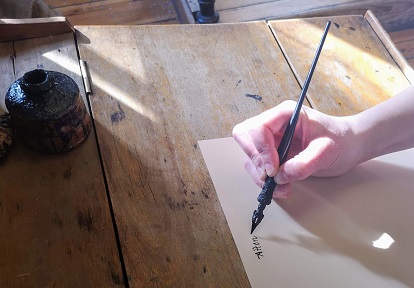 woman writing a letter with old-fashioned pen and ink