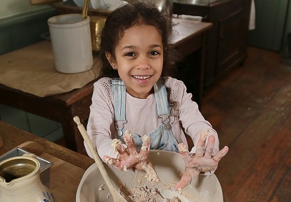 student learns traditional 19th century baking techniques