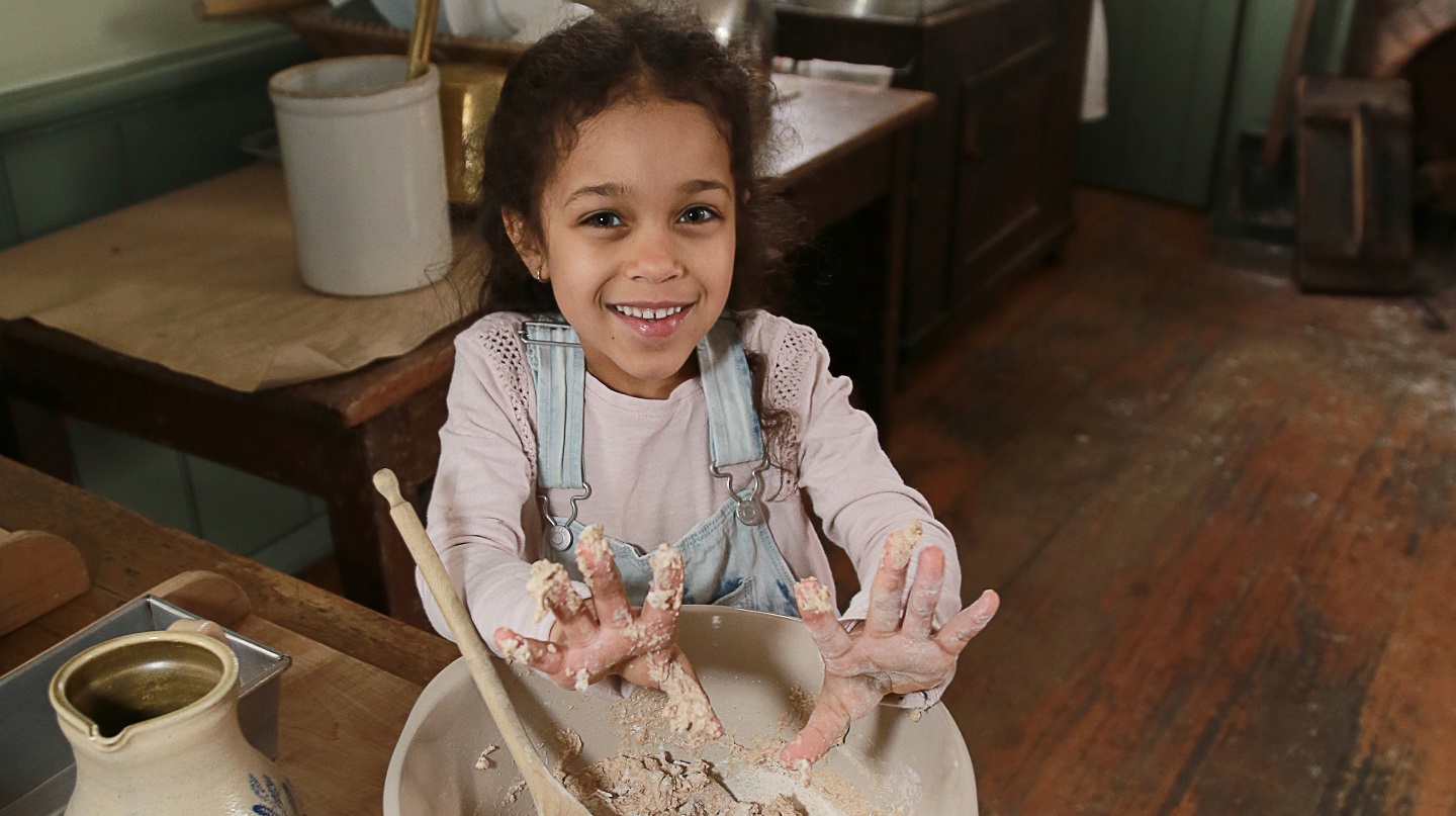 student learns traditional 19th century baking techniques