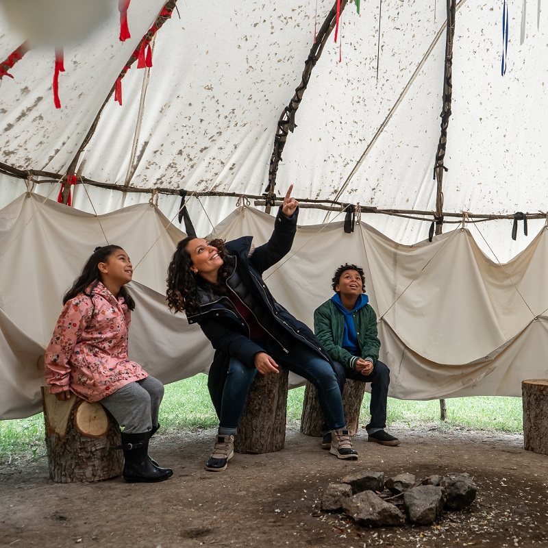 mother and children visit the Wiigiwam at Black Creek Pioneer Village